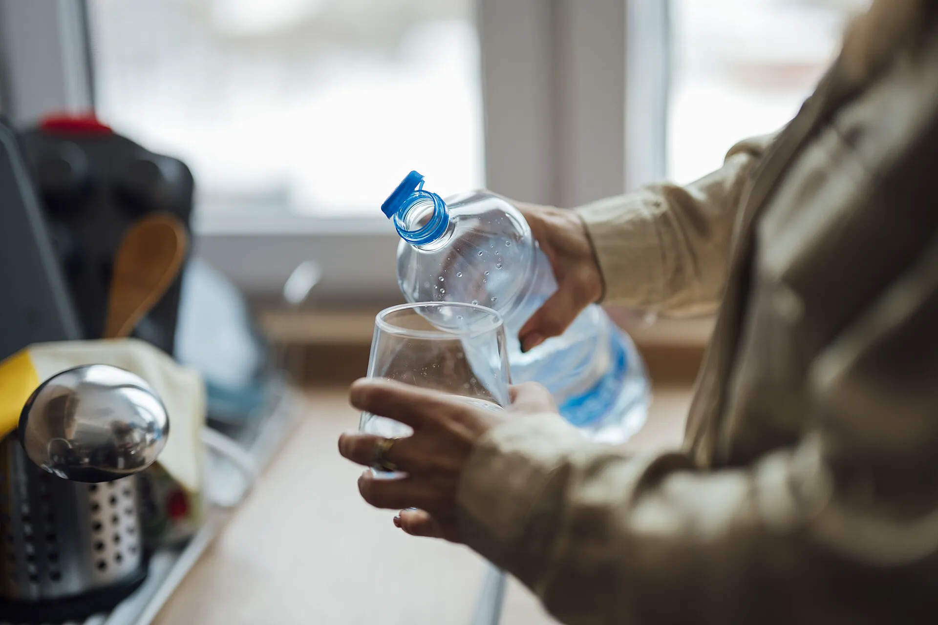 Water pouring from a bottle into a glass